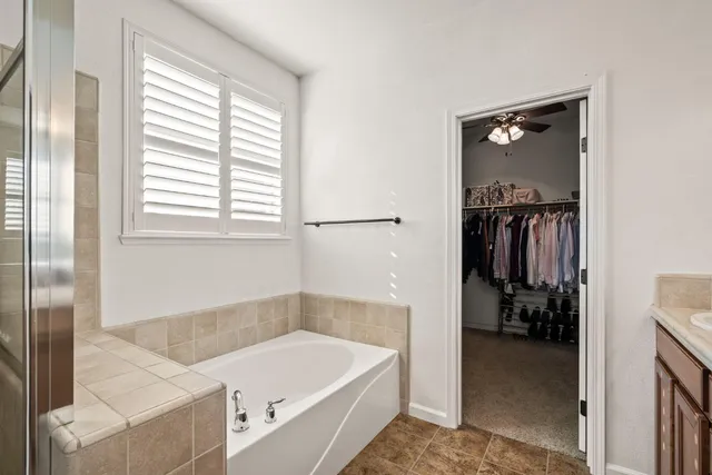 a bathroom with a tub and a shower
