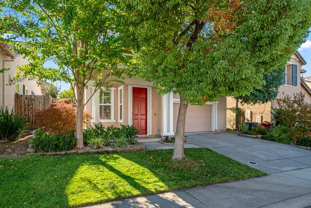 a front view of house with yard and green space