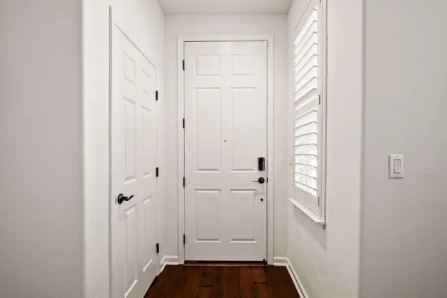 a view of front door with wooden floor