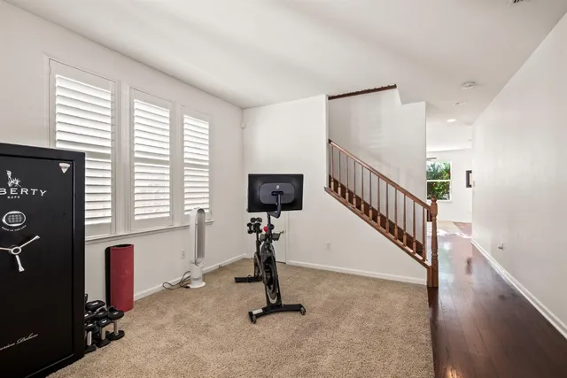 a view of a livingroom with wooden floor and windows