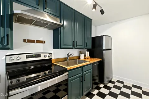a kitchen with stainless steel appliances a stove a sink and a refrigerator