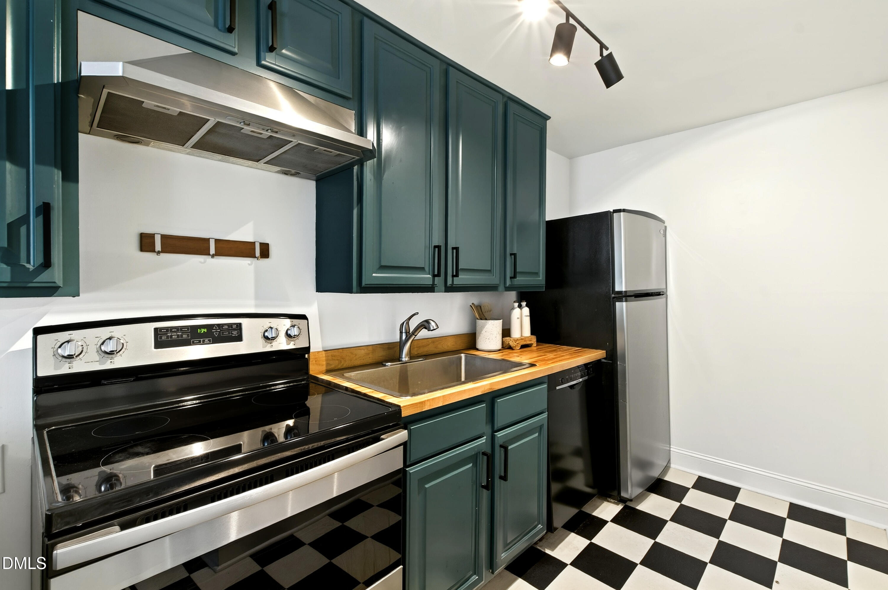 913 Washington Street Durham, NC 27701 - Photo 6 of 37 a kitchen with stainless steel appliances a stove a sink and a refrigerator