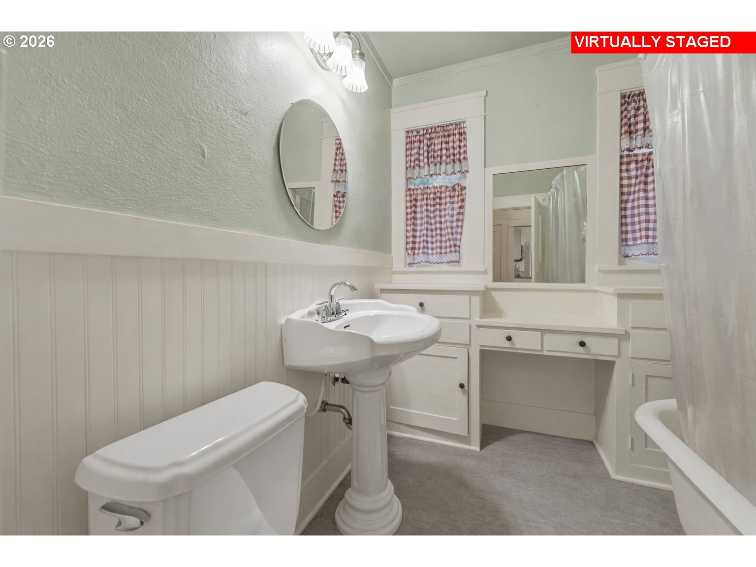 706 West B Street Rainier, OR 97048 - Photo 17 of 47 a bathroom with a toilet sink and mirror