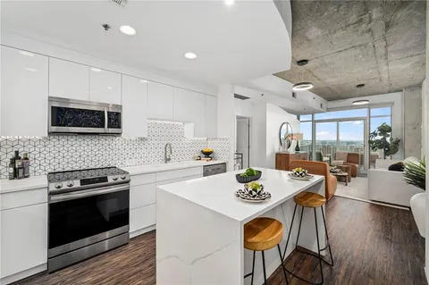 a kitchen with a table chairs stove and microwave