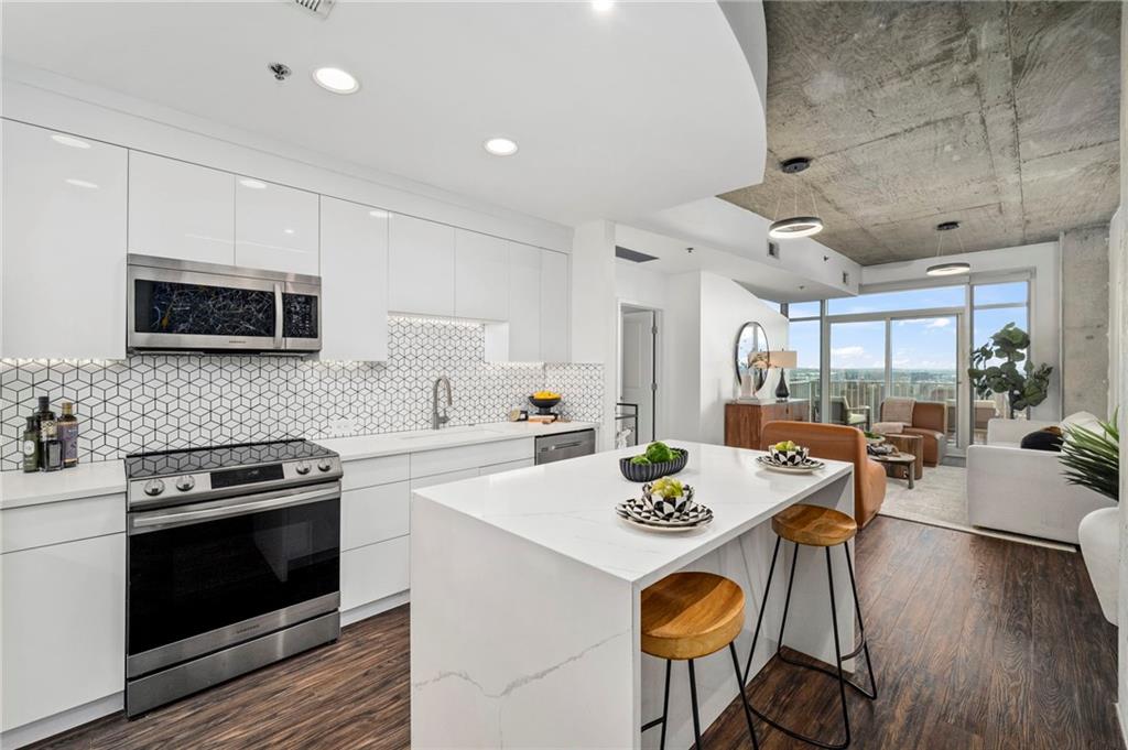 a kitchen with a table chairs stove and microwave