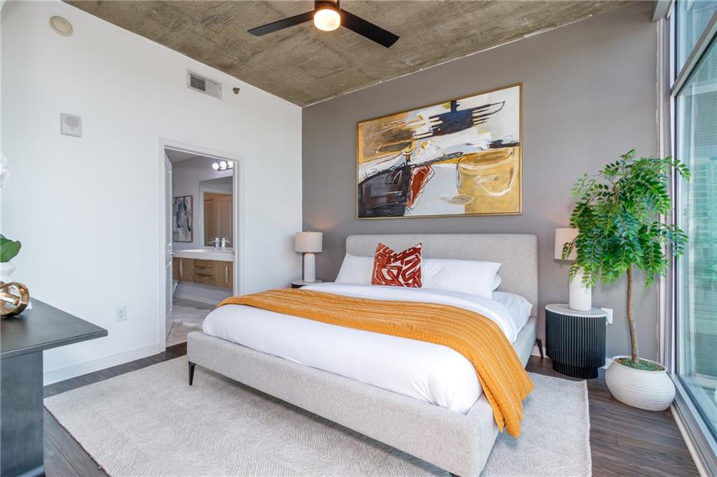 250 Pharr Road Northeast, Unit 1116 Atlanta, GA 30305 - Photo 12 of 45 a bedroom with a bed and a potted plant
