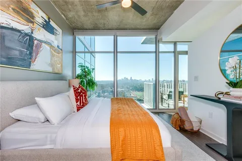 a bed sitting in a bedroom next to a window