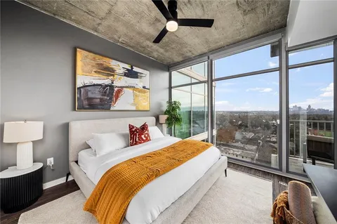 a spacious bedroom with a bed and a large window