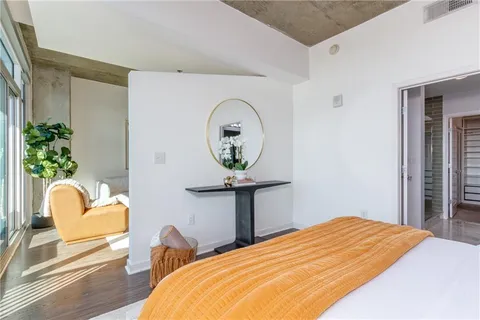 a bedroom with a bed and a chair