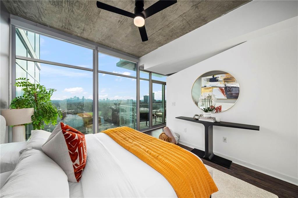 250 Pharr Road Northeast, Unit 1116 Atlanta, GA 30305 - Photo 16 of 45 a bedroom with a bed a mirror on dresser and a large window