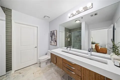 a spacious bathroom with a double vanity sink and a mirror