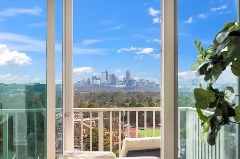a view of a balcony with floor to ceiling windows with wooden floor