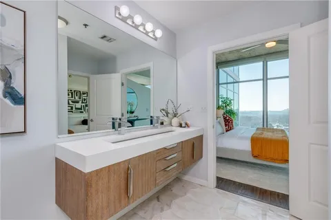 a view of living room with furniture and a large mirror