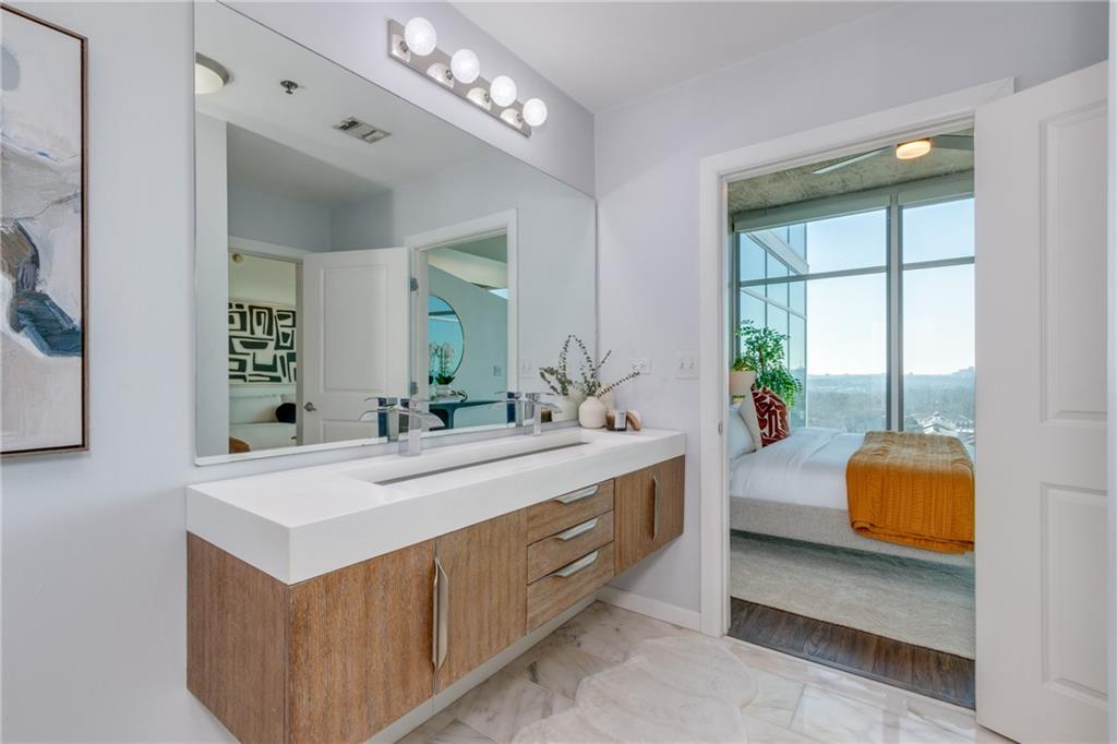 250 Pharr Road Northeast, Unit 1116 Atlanta, GA 30305 - Photo 22 of 45 a view of living room with furniture and a large mirror