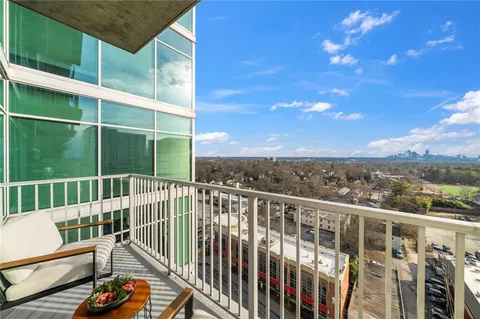 a dining hall with stainless steel appliances kitchen island granite countertop a table chairs and a large window