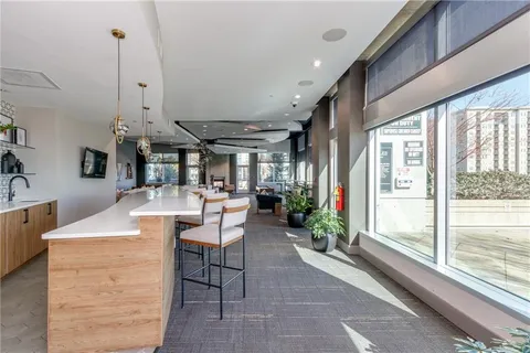 a room with table chairs and wooden floor