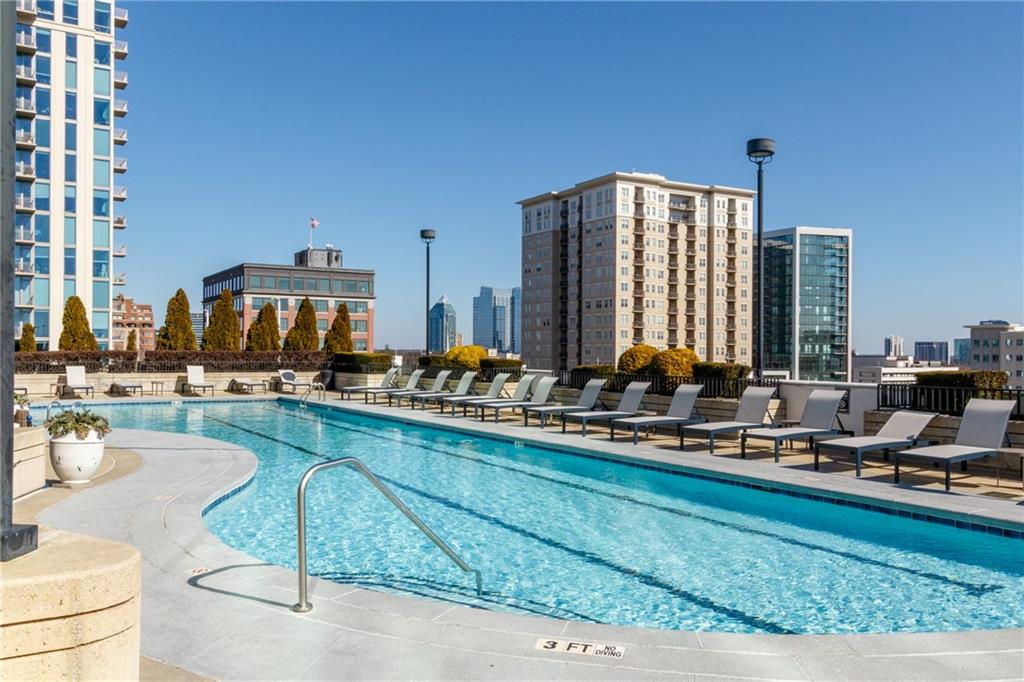250 Pharr Road Northeast, Unit 1116 Atlanta, GA 30305 - Photo 35 of 45 a view of a swimming pool with outdoor seating