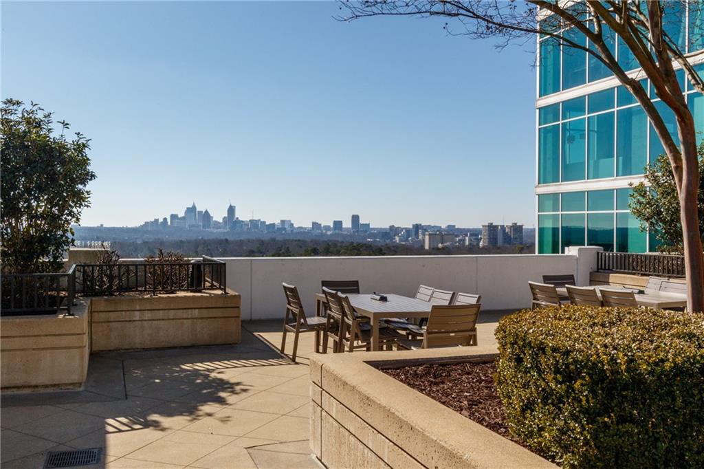 250 Pharr Road Northeast, Unit 1116 Atlanta, GA 30305 - Photo 37 of 45 a view of a terrace with couches and a fire pit