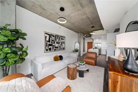 a living room with furniture and a potted plant