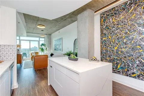 a view of living room with furniture and wooden floor