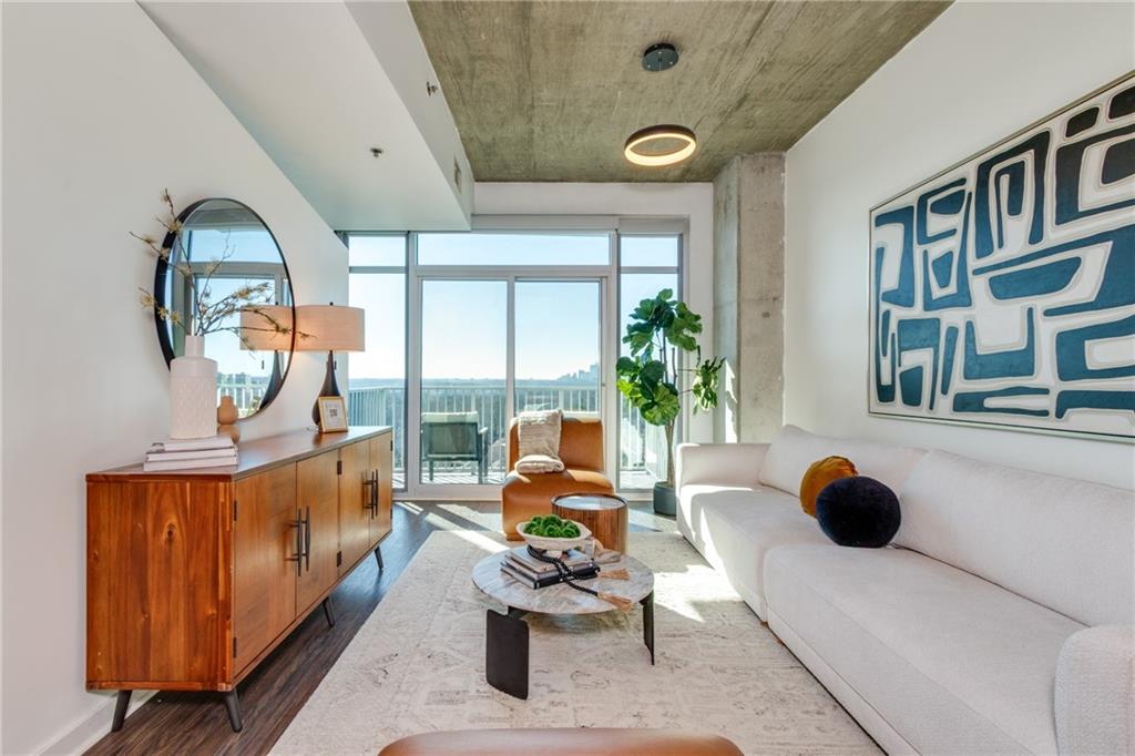 250 Pharr Road Northeast, Unit 1116 Atlanta, GA 30305 - Photo 7 of 45 a living room with furniture and a potted plant