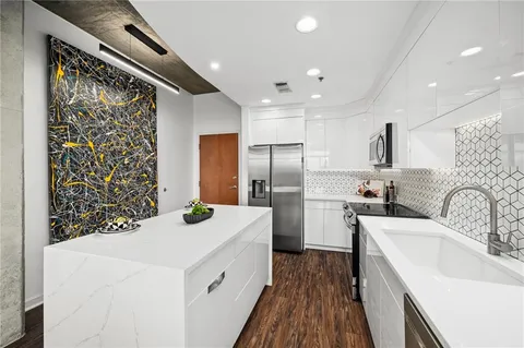 a kitchen with a sink stove and refrigerator