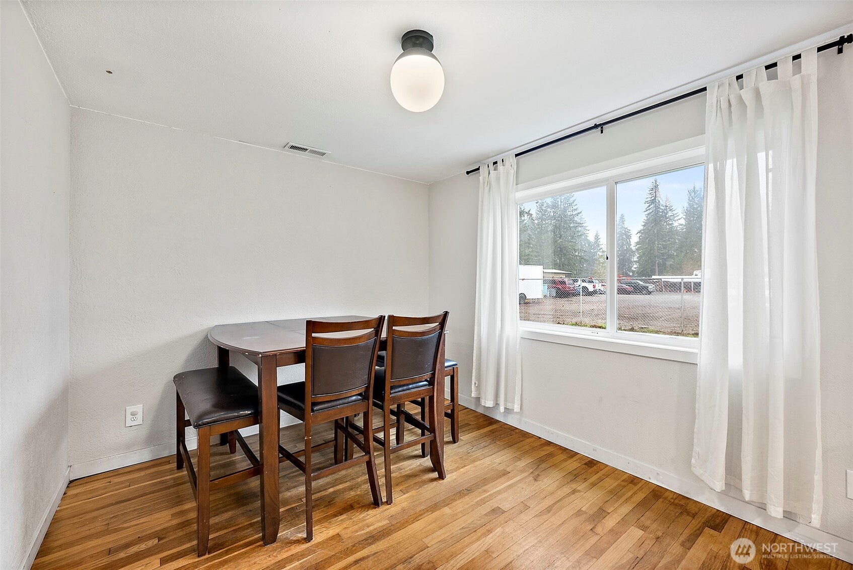 2949 South Bay Road Northeast Olympia, WA 98506 - Photo 16 of 29 a view of a dining room with furniture window and wooden floor