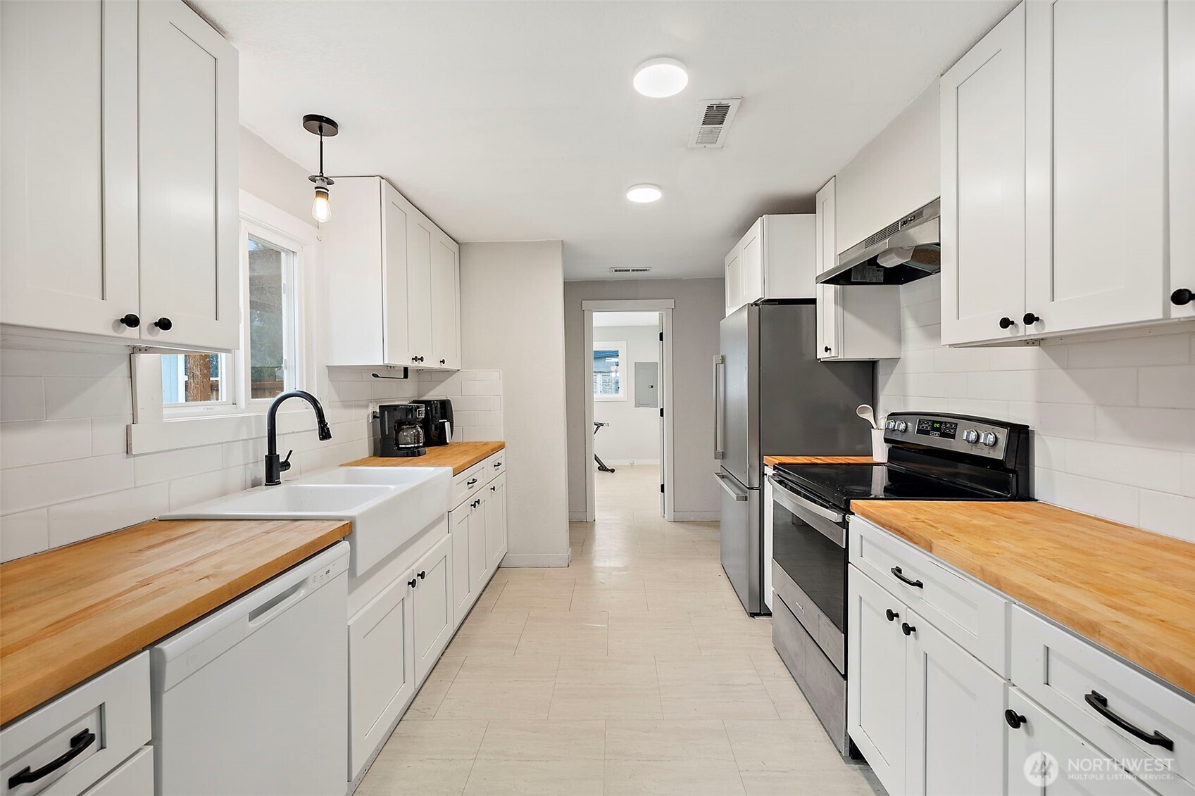 2949 South Bay Road Northeast Olympia, WA 98506 - Photo 18 of 29 a large white kitchen with stainless steel appliances granite countertop a stove and a sink