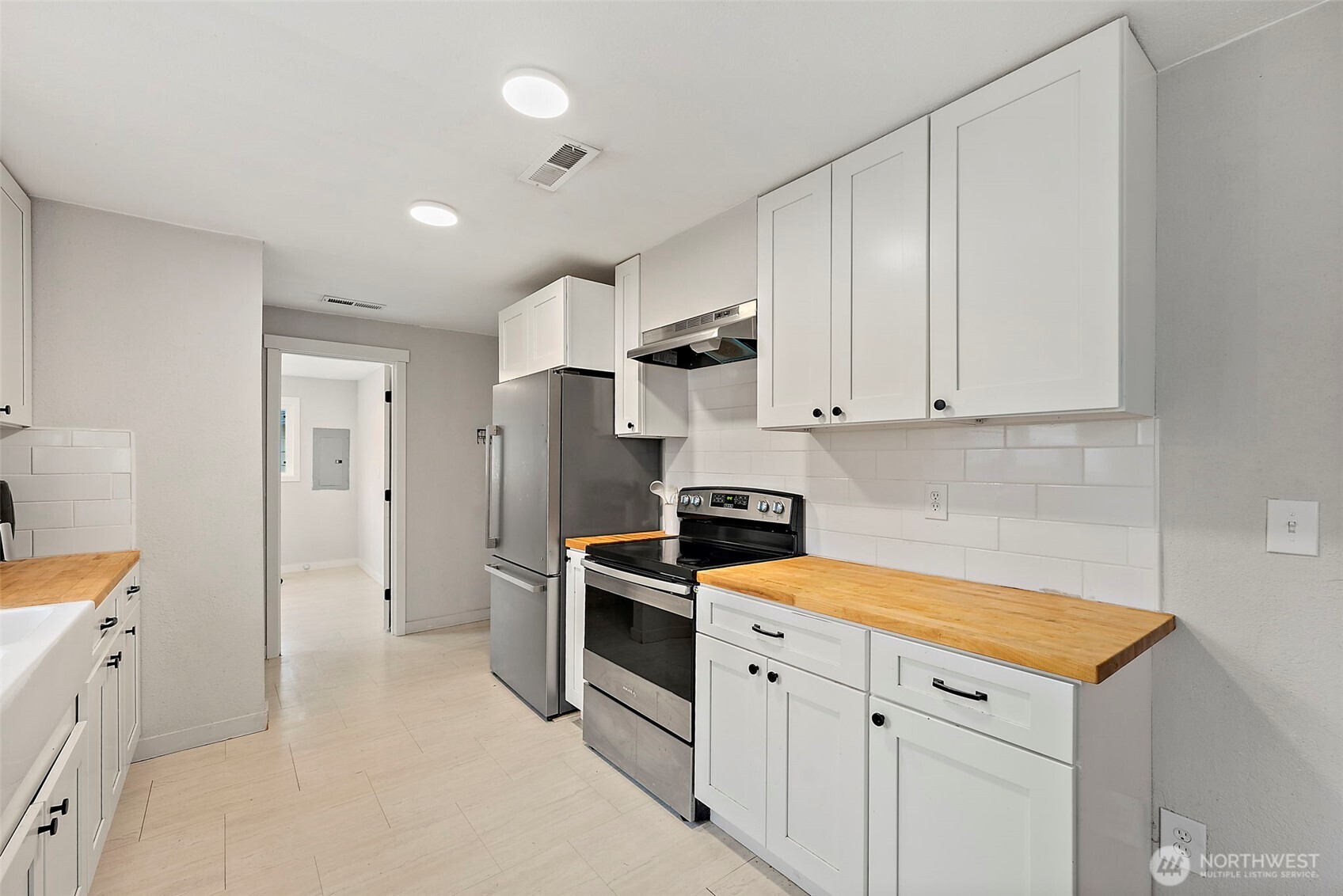 2949 South Bay Road Northeast Olympia, WA 98506 - Photo 20 of 29 a kitchen with stainless steel appliances white cabinets and a refrigerator