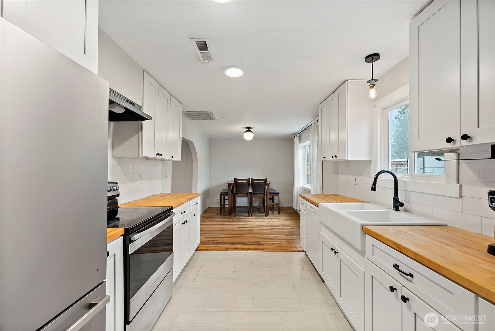2949 South Bay Road Northeast Olympia, WA 98506 - Photo 21 of 29 a large kitchen with stainless steel appliances granite countertop a sink and cabinets