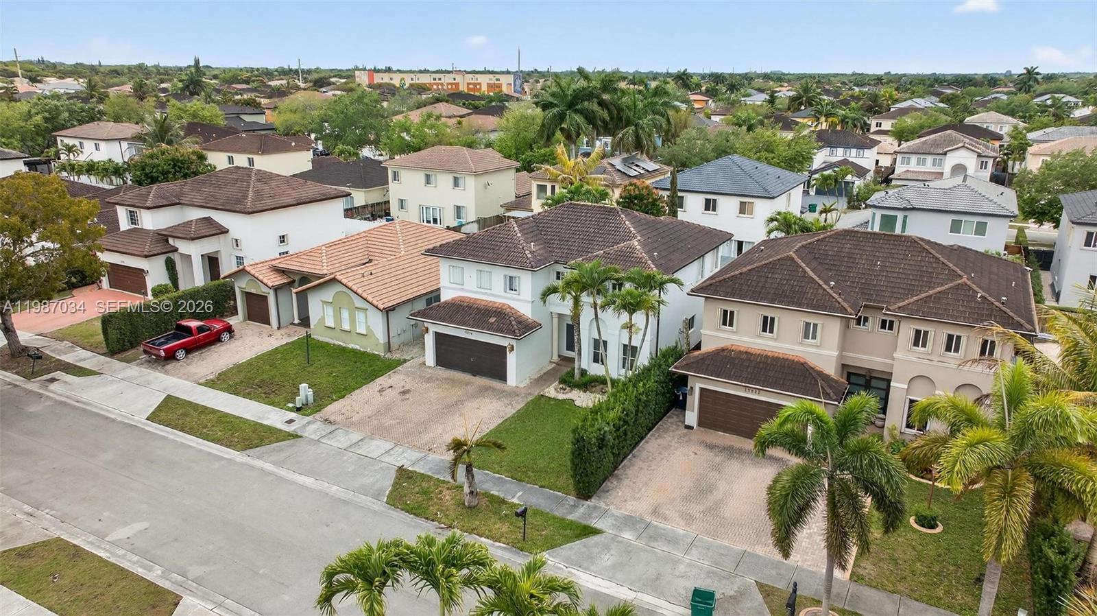 15874 Southwest 138th Terrace, Unit 1 Miami, FL 33196 - Photo 11 of 12 an aerial view of multiple houses with a yard