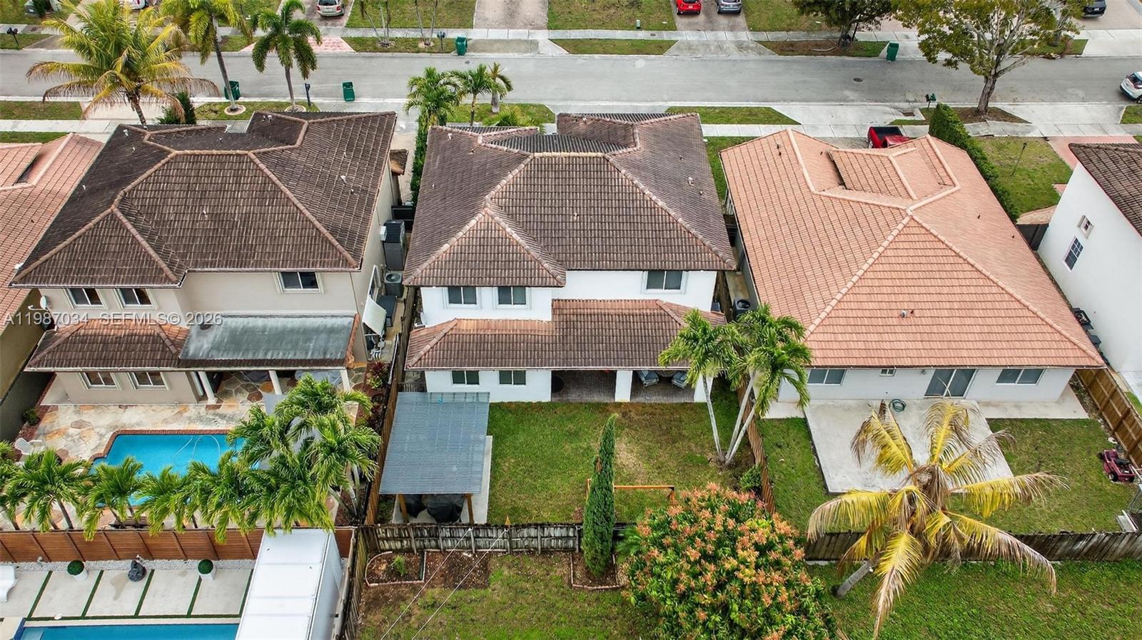 15874 Southwest 138th Terrace, Unit 1 Miami, FL 33196 - Photo 5 of 12 an aerial view of multiple houses with yard