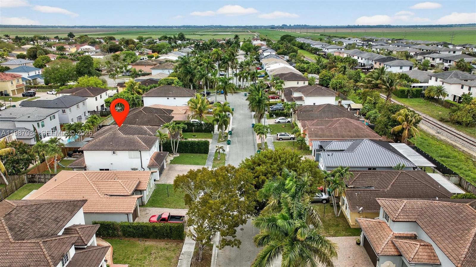 15874 Southwest 138th Terrace, Unit 1 Miami, FL 33196 - Photo 9 of 12 an aerial view of residential houses with outdoor space and swimming pool