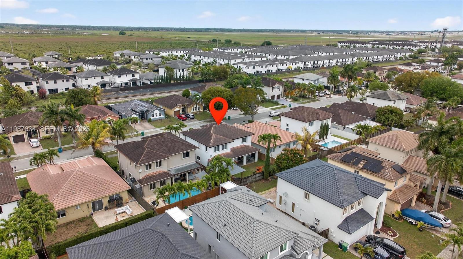 15874 Southwest 138th Terrace, Unit 1 Miami, FL 33196 - Photo 10 of 12 an aerial view of residential building with outdoor space