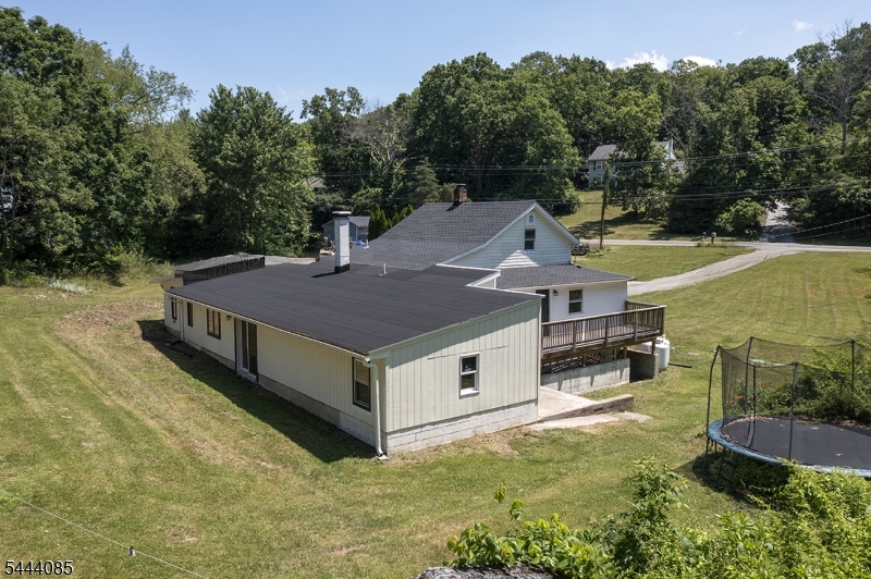 79 Lake Wallkill Road Vernon, NJ 07461 - Photo 2 of 27 a aerial view of a house with swimming pool next to a yard