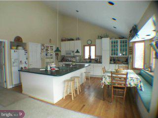605 Bobbin Mill Road Media, PA 19063 - Photo 3 of 5 a kitchen with stainless steel appliances kitchen island granite countertop a stove and a sink