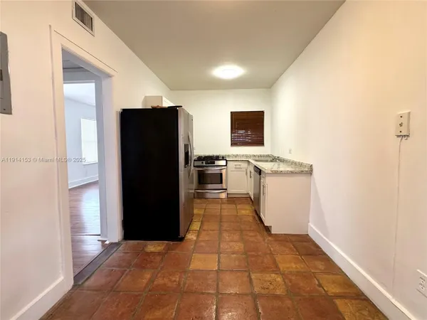 a view of a kitchen with refrigerator and microwave