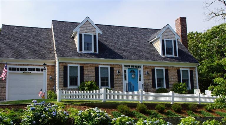 front view of brick house with a yard