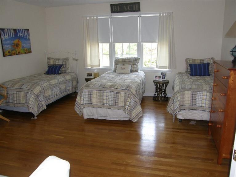 9 Shady Lane Chatham, MA 02633 - Photo 11 of 15 a bedroom with a bed and wooden floor