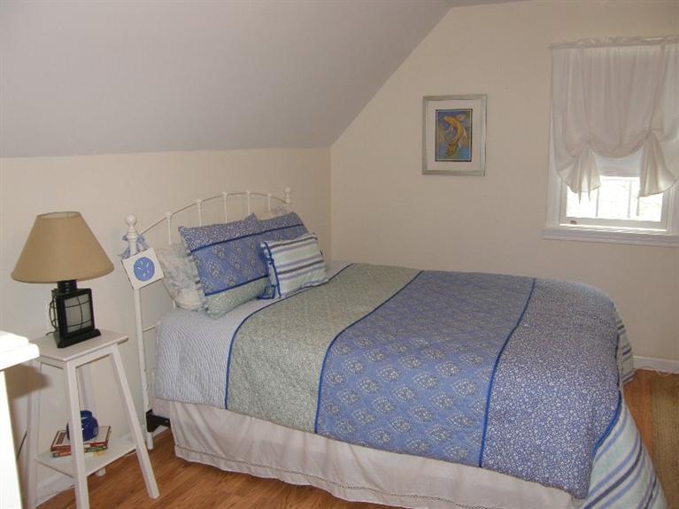 9 Shady Lane Chatham, MA 02633 - Photo 13 of 15 a bedroom with a bed and a lamp