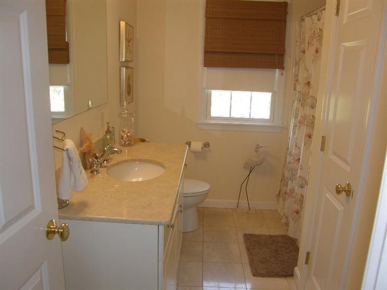 9 Shady Lane Chatham, MA 02633 - Photo 14 of 15 a bathroom with a granite countertop sink a toilet and shower
