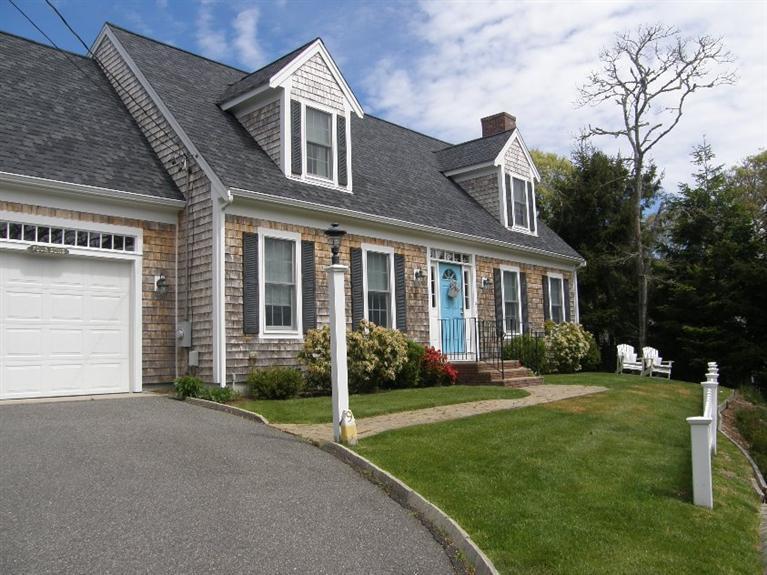 9 Shady Lane Chatham, MA 02633 - Photo 2 of 15 a front view of a house with a yard and porch