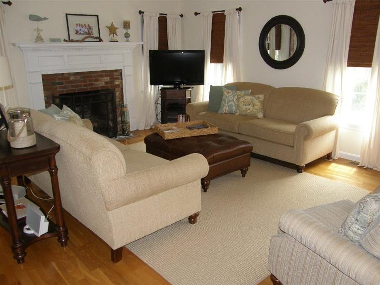 9 Shady Lane Chatham, MA 02633 - Photo 6 of 15 a living room with furniture a flat screen tv and a fireplace