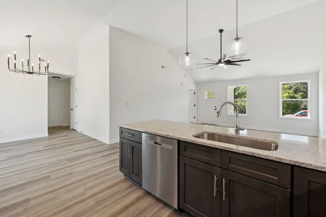 a view of a kitchen counter space a sink and wooden floor