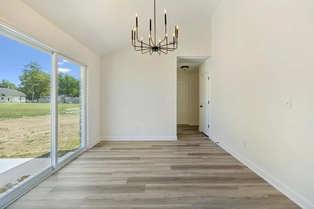 a view of a chandelier fan and wooden floor