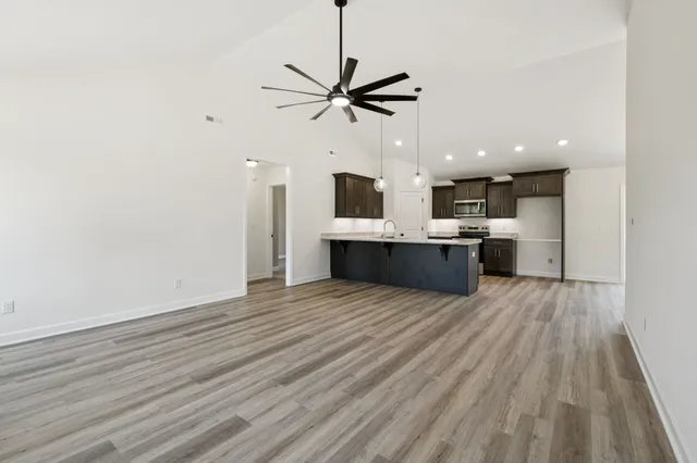 a view of a kitchen with a sink and a stove top oven