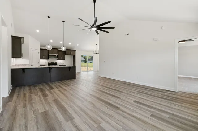 a kitchen with stainless steel appliances granite countertop a sink refrigerator and cabinets