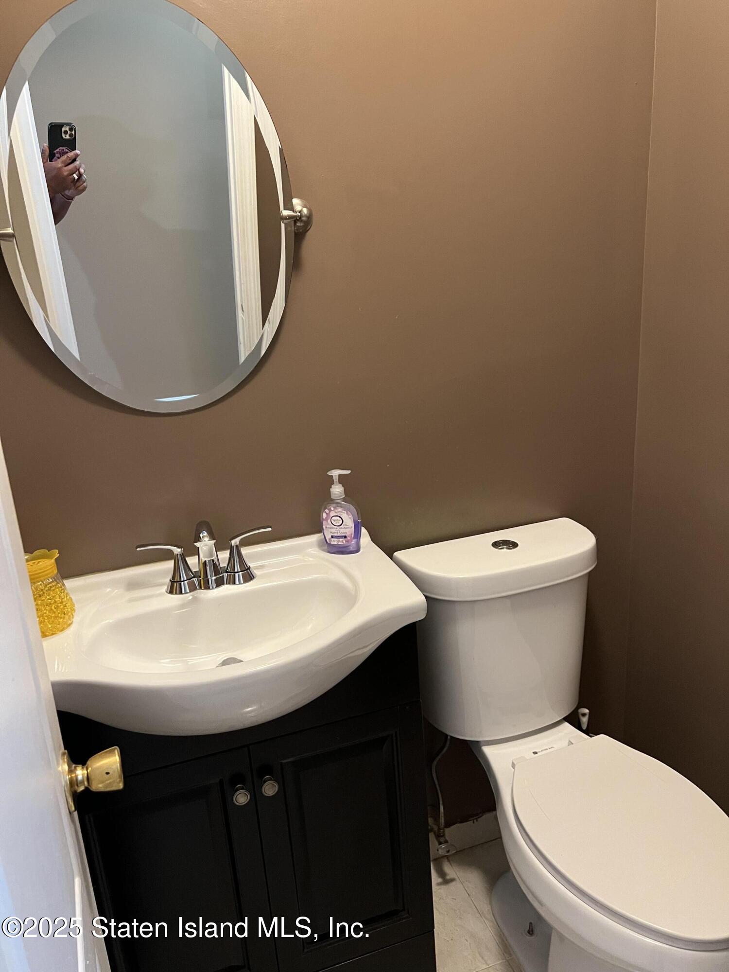 256 Maple Parkway Staten Island, NY 10303 - Photo 13 of 21 a bathroom with a sink and a mirror