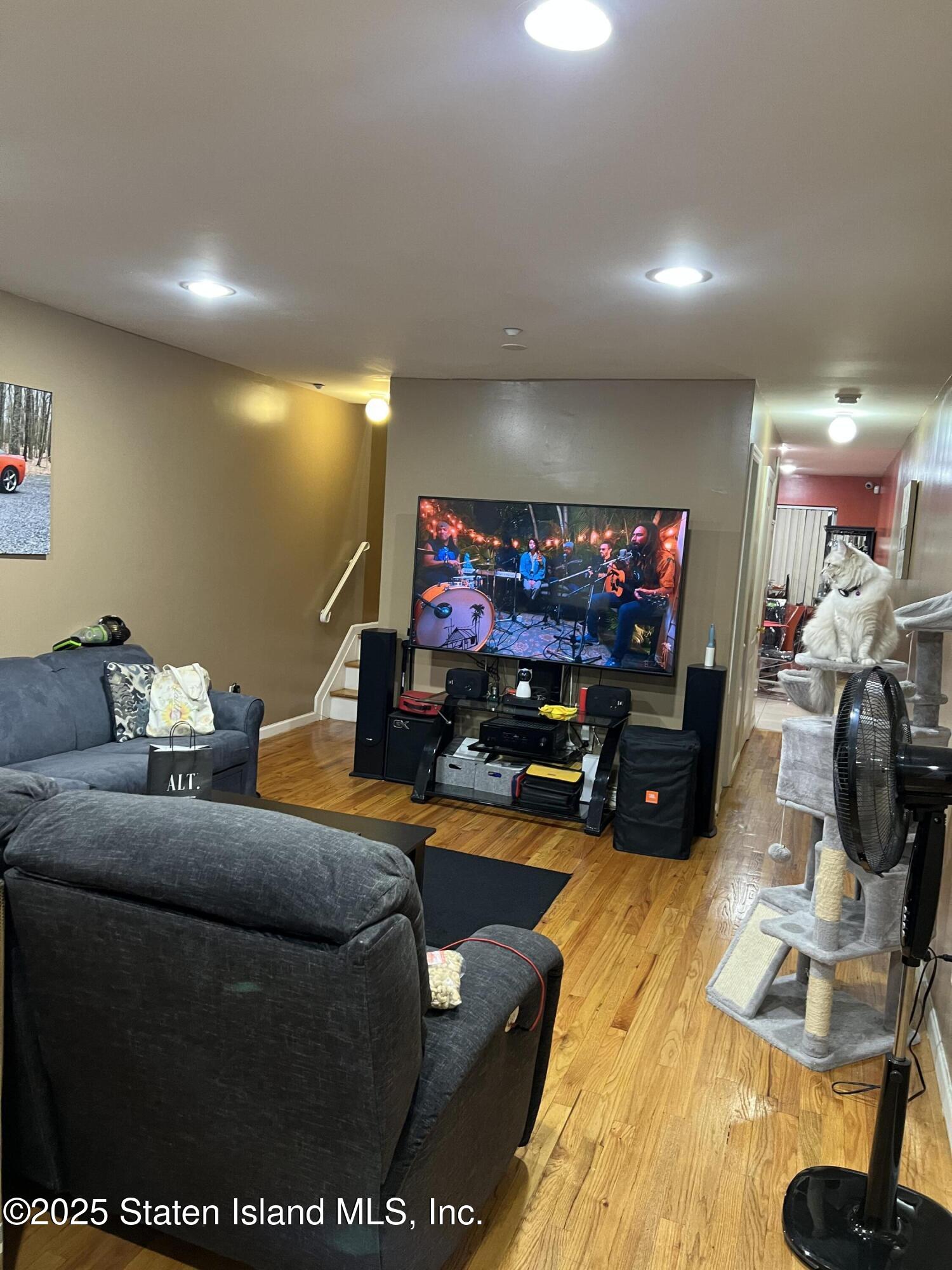 256 Maple Parkway Staten Island, NY 10303 - Photo 14 of 21 a living room with furniture and a flat screen tv