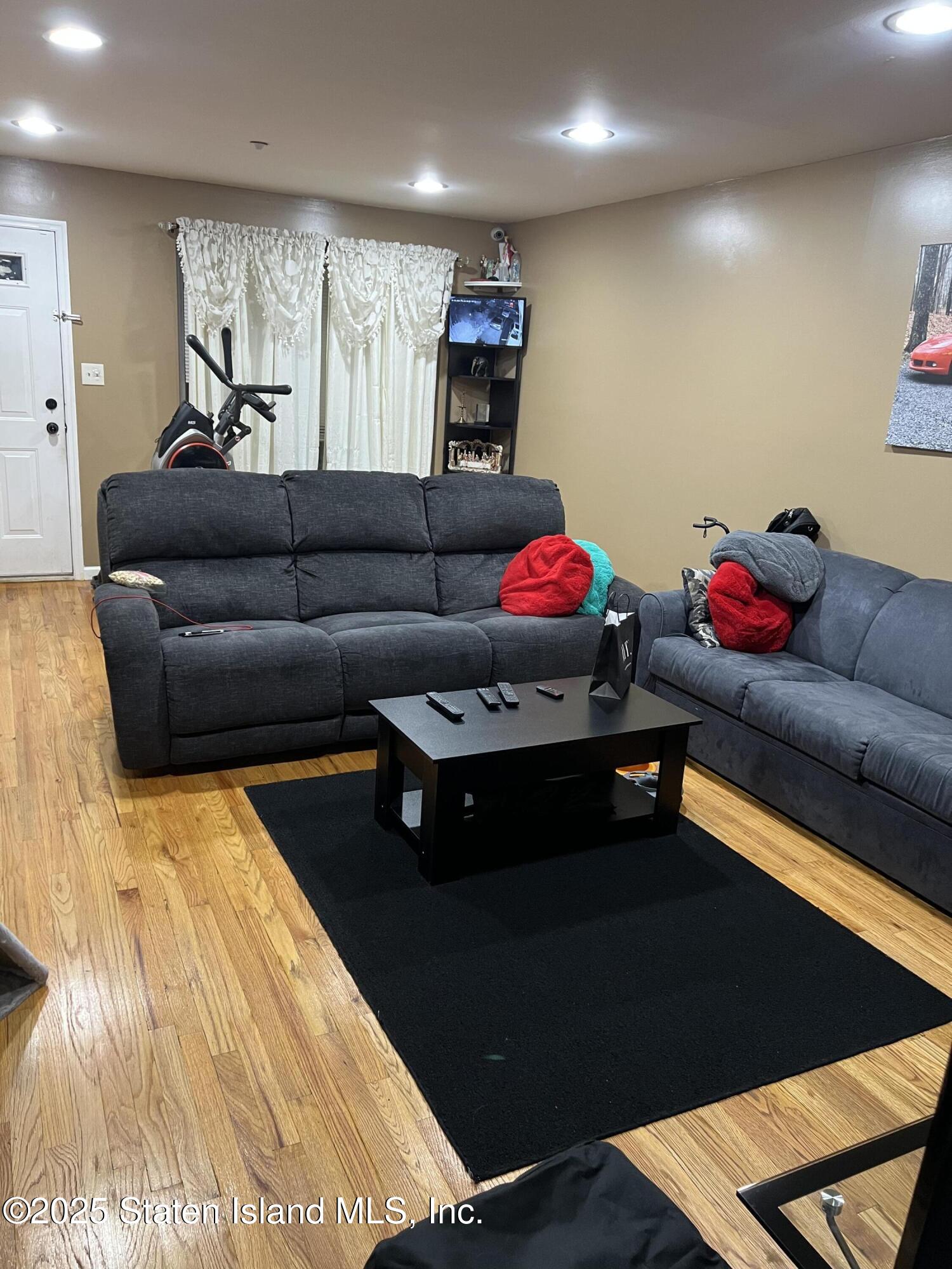 256 Maple Parkway Staten Island, NY 10303 - Photo 15 of 21 a living room with furniture and a wooden floor